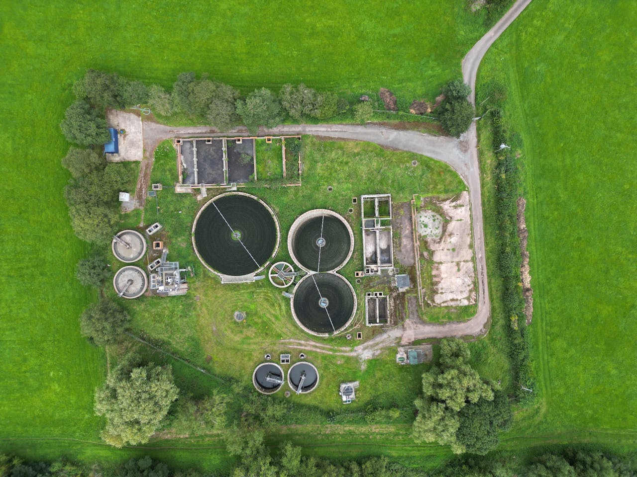 why-choose-us-02 Aerial view of a wastewater treatment plant surrounded by lush greenery in Crickhowell, Wales.